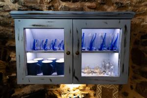 a cabinet with blue glass vases in it at Byzantine Home in the Castle in Mestá