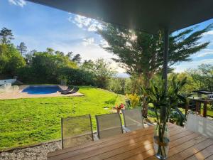 a patio with a table and chairs and a pool at Casa Caldes de Malavella, 4 dormitorios, 8 personas - ES-209-82 in Caldes de Malavella