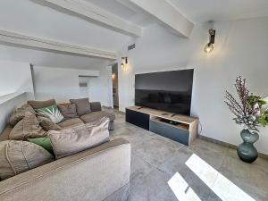a living room with a couch and a flat screen tv at Maison Manosque, 4 pièces, 6 personnes - FR-1-752-5 in Manosque