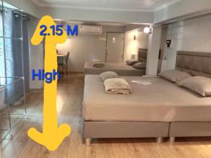 une chambre avec deux lits et un numéro 4 jaune dans l'établissement Baankhon Private room in Thai house Adult only Check in by yourself, à Bangkok