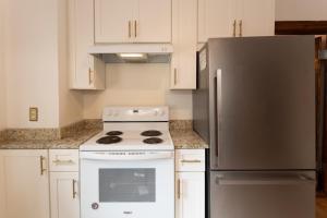 a kitchen with a white stove and a refrigerator at 5 BR Downtown Savannah GA in Savannah