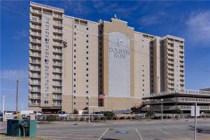 a large building with a sign on the front of it at Oceanfront Condo with Pool and Hot Tub! in Virginia Beach