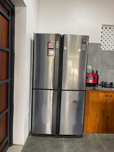 a stainless steel refrigerator in a kitchen at AKIRA VILLA _ Venuestay in Ba Vì