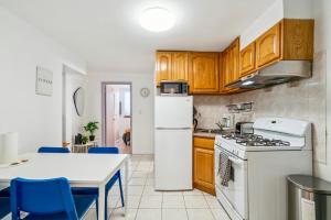 eine Küche mit einem weißen Kühlschrank und einem Tisch in der Unterkunft 4 Bedroom Paradise in the Heart of Lower Manhattan in New York