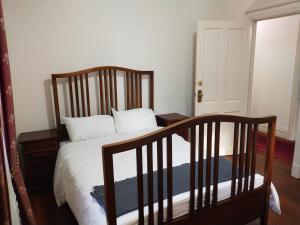 a bedroom with a bed with a wooden crib at A peaceful room in Northbridge with free parking in Perth