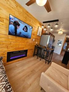 a living room with a tv on a wooden wall at Matchbox desert oasis hot tub, pet friendly! in Las Cruces +30 photos