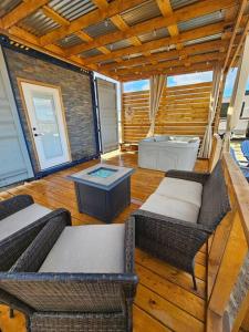 a room with chairs and a table and a tub at Matchbox desert oasis hot tub, pet friendly! in Las Cruces