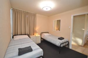 a room with two beds and a window at Riverview Holiday Apartment 28 - Kalbarri WA in Kalbarri