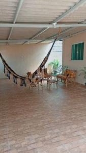 a room with chairs and a hammock in it at Recanto da Chapada in Alto Paraíso de Goiás