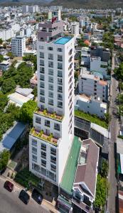 an aerial view of a white building in a city at Gibson Hotel Nha Trang in Nha Trang