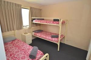 a room with two bunk beds and a window at Riverview Holiday Apartment 65 - Kalbarri WA in Kalbarri