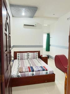 ein Schlafzimmer mit einem Bett in einem Zimmer in der Unterkunft KHÁCH SẠN HOÀNG TRÍ 89 (HOANG TRI 89 HOTEL) in Hố Nai