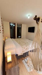a hotel room with a bed and a tv at La mejor habitacion privada del sector in Mosquera
