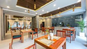 a restaurant with wooden tables and chairs and a counter at The Luxury in Siem Reap