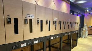 a row of lockers lined up in a gym at Henn na Hotel Osaka Namba in Osaka
