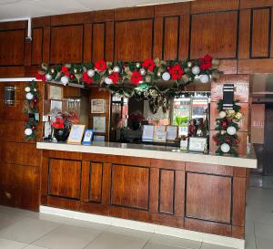 a restaurant counter with christmas wreaths on it at Bamboo Garden Bussiness Inn in Dipolog