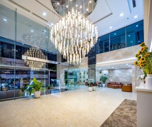 a lobby with chandeliers in a building at Gibson Hotel Nha Trang in Nha Trang