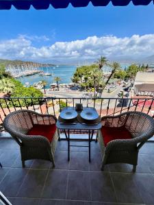 a patio with two chairs and a table on a balcony at MEK HARBOUR view in Fethiye