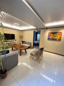 a living room with a couch and a table at P&M Final Option Beach Resort in San Juan