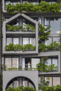 a building with lots of plants on the balconies at The Leaf Boutique in Da Nang