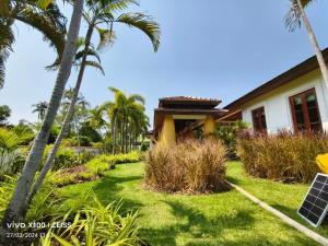 a house with palm trees in front of it at Project 17 in Hua Hin