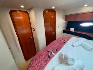 a small room with a bed with a pink blanket at Motor Boat Accommodation in Torquay