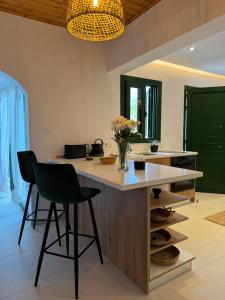 a kitchen with a large island with two chairs and a counter at Pirella House in Limassol