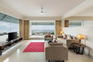 a living room with a couch and a tv at TatSaraasa Resort & Spa, Udaipur in Udaipur