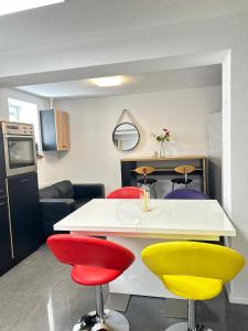 a kitchen with colorful chairs and a table at Fe Wo Auf der Alb 