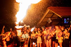 a group of people standing in a crowd at a concert at Base Party Hostel in Ao Nang Beach