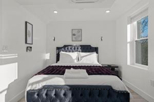 a bedroom with a large bed in a white room at New Season Royals, Airport West in Chester