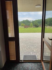 an open door with a view of a driveway at Penzion Čavisov in Čavisov