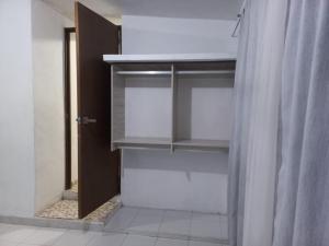 a bathroom with a walk in closet with a curtain at CASA ALTABRISA in Mérida