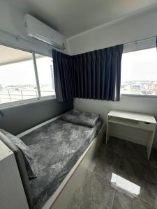 a small room with a bed and a window at View Talay6 by Blue Ocean Suite in Pattaya Central