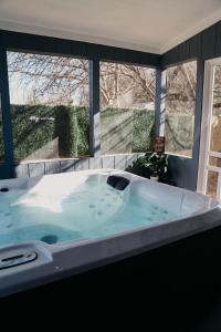 a large bath tub in front of a window at Creed's Cottage at Four Oaks in New Braunfels
