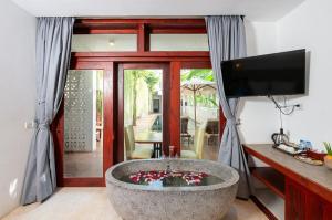 a living room with a bath tub with a television at Victoria Central Residence in Siem Reap