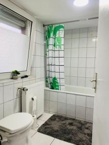 a white bathroom with a toilet and a shower at Gemütliches freistehendes Haus in der Nähe von Frankfurt in Kelkheim