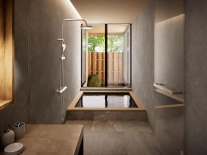 a bathroom with a shower with a window at Hakone Retreat villa 1f in Hakone