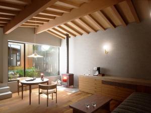 a living room with a table and a fireplace at Hakone Retreat villa 1f in Hakone