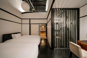 Ein Bett oder Betten in einem Zimmer der Unterkunft Shobu an Machiya House