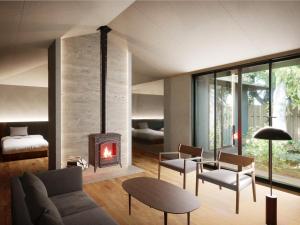a living room with a fireplace and a couch at Hakone Retreat villa 1f in Hakone