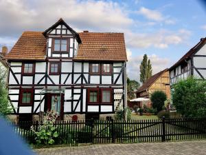 ein altes Schwarz-Weiß-Haus mit einem Zaun in der Unterkunft Hansel and Gretel in Kassel