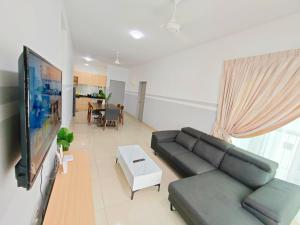 a living room with a couch and a flat screen tv at Razak City 2 or 3 bedroom KLCC View Sungai Besi, Kuala Lumpur in Kuala Lumpur