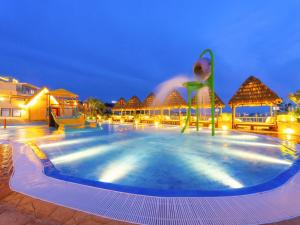 a large swimming pool in a resort at night at Latterace Resort in Yeosu