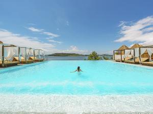 a woman swimming in a large swimming pool at Latterace Resort in Yeosu