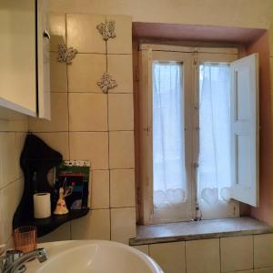 a bathroom with a sink and a window at Il giardino di Emilia in Raviscanina
