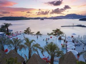 a group of people in a swimming pool at a resort at Yeosu Calacatta Hotel & Resort in Yeosu