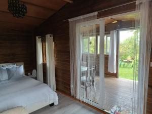 a bedroom with a bed and a sliding glass door at Le Clos des Mimosas in La Plaine des Palmistes
