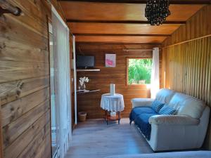 a living room with a couch and a table at Le Clos des Mimosas in La Plaine des Palmistes