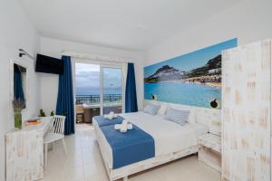 a bedroom with a bed and a view of the beach at Hotel Ziakis in Pefki